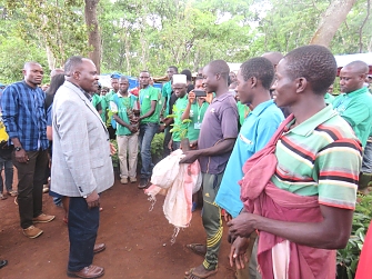 Beneficiaries receiving tree seedlings from Kigoma Regional Commissioner in Nduta camp