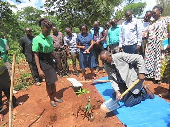 Kigoma Regional commissioner planting the memorial tree at Ministery of Home Affairs office at Nduta in Kibondo District