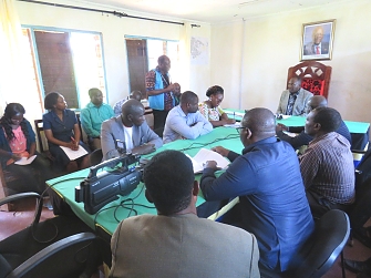 Kibondo UNHCR HoSO representative briefing the Regional Commissioner on environment activities in the camps
