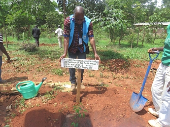 UNHCR Kibondo HoSO representative was standing near his memorial tree planted at MHA office premises in Nduta camp