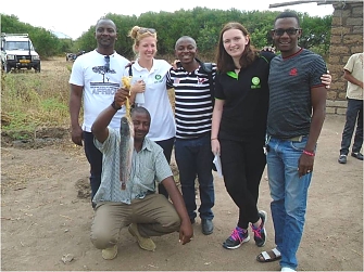 OXFAM guest from Irend (Miss Niva and her friend), OXFAM staff, REDESO staff and UWASALU chairperson having a photo with Catfish kept From the Fish pond at Lubaga Fish Pond.