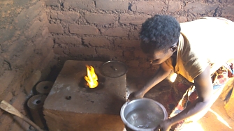 One of beneficiary uses insert stove at Mtendeli in Kibondo District